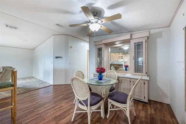 a dining room with furniture and wooden floor