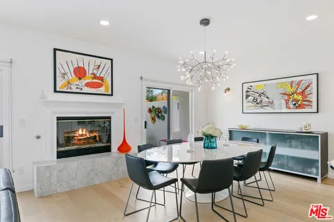 a living room with furniture a chandelier and a fireplace