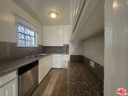 a kitchen with a stove and a white cabinets