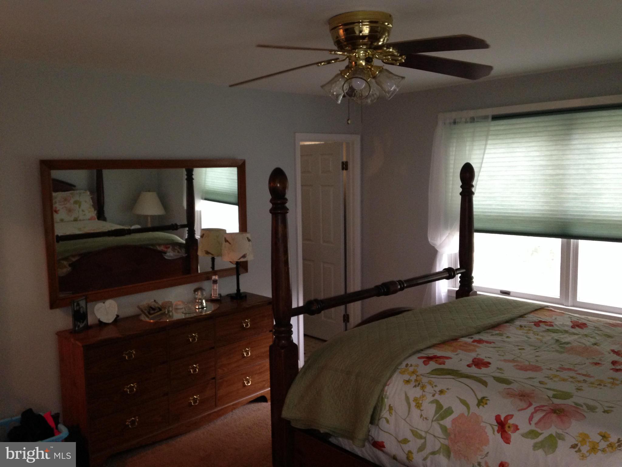 18608 Upper Beckleysville Road Hampstead, MD 21074 - Photo 22 of 29 a bedroom with a bed and a flat tv screen on dresser