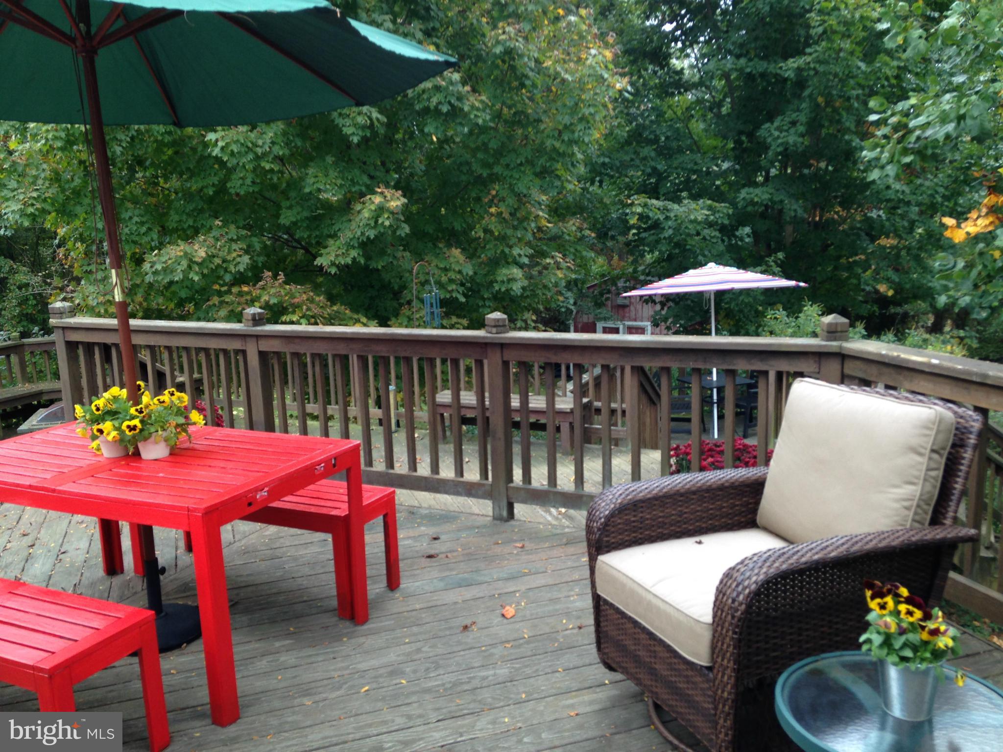 18608 Upper Beckleysville Road Hampstead, MD 21074 - Photo 28 of 29 a patio with wooden floor a yard a table and chairs