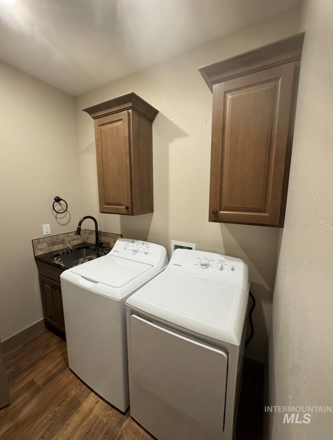 1346 Zephlyn Street Twin Falls, ID 83301 - Photo 12 of 34 Laundry area with cabinet space, dark wood-type flooring, and washing machine and clothes dryer