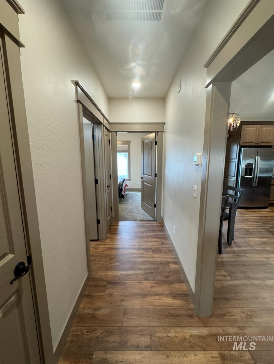 1346 Zephlyn Street Twin Falls, ID 83301 - Photo 25 of 34 Hallway featuring dark wood-style floors and a chandelier