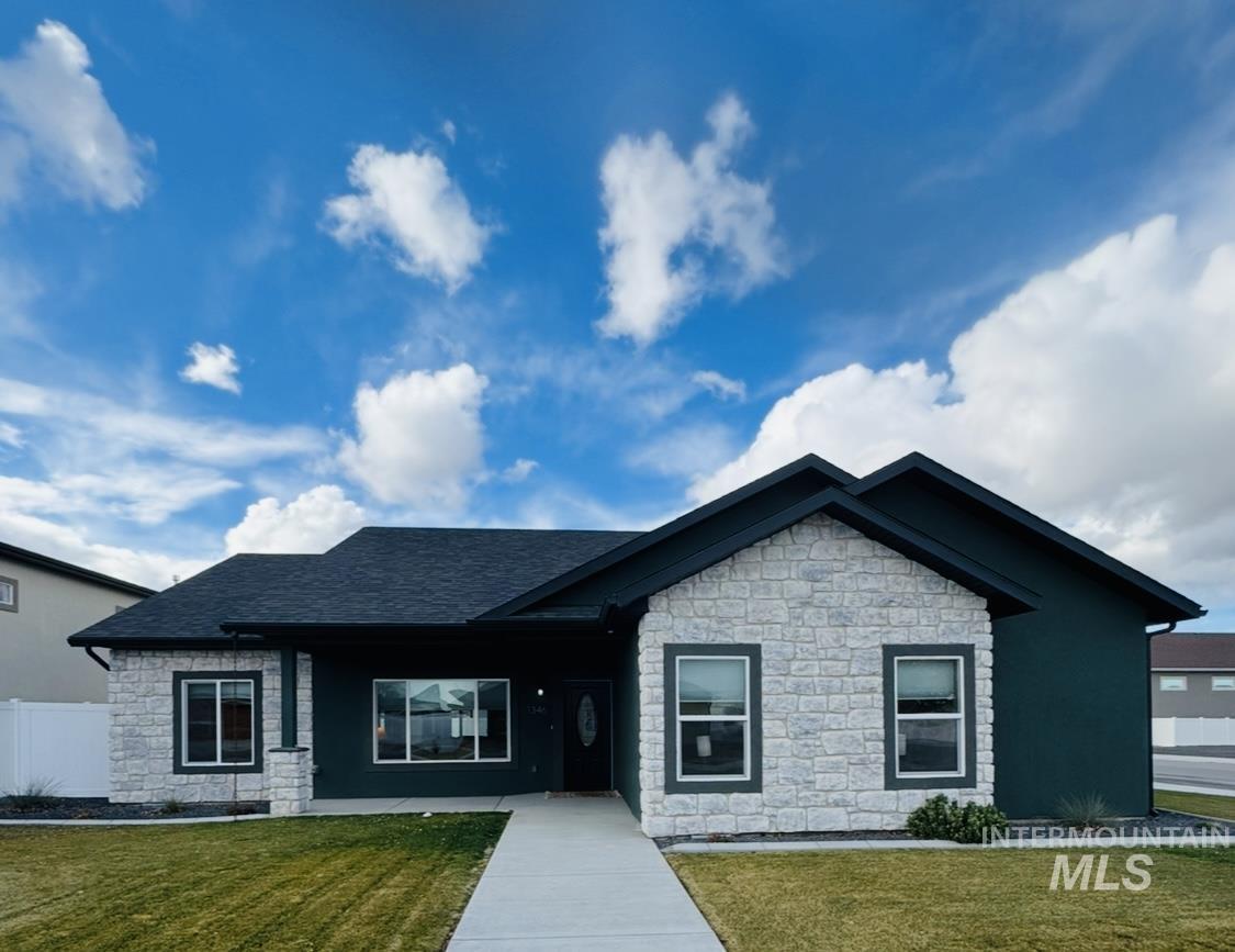1346 Zephlyn Street Twin Falls, ID 83301 - Photo 3 of 34 View of front of home featuring stone siding, roof with shingles, and covered porch