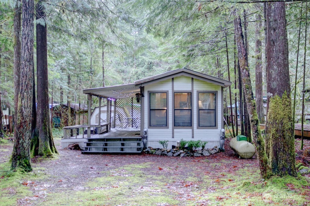 96 Sunset Circle Maple Falls, WA 98266 - Photo 1 of 31 a backyard of a house with yard table and chairs