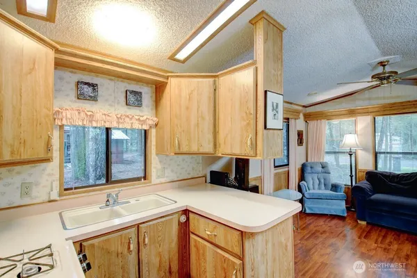 a kitchen with a stove a sink and a refrigerator