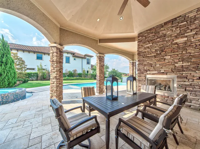 a view of a patio with a table and chairs