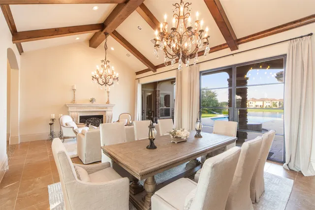 a view of a dining room with furniture a chandelier and wooden floor