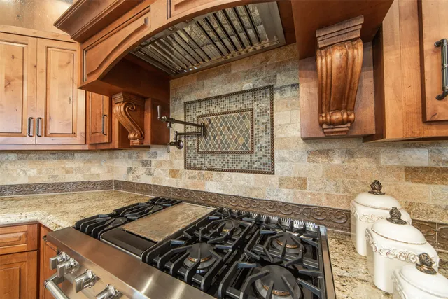 a kitchen with a stove a microwave and cabinets