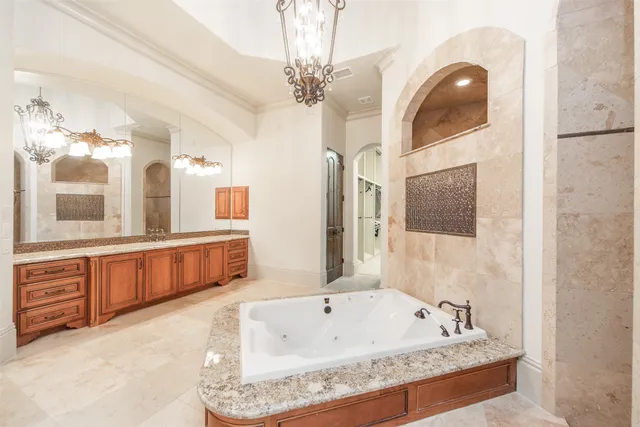 a spacious bathroom with a tub a double vanity sink and a mirror