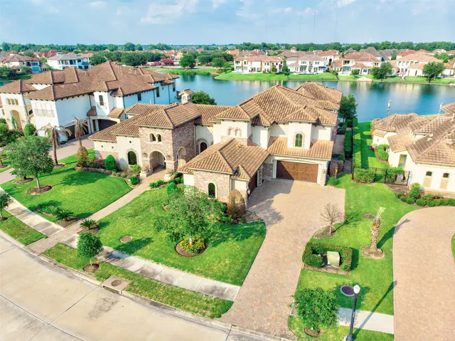 an aerial view of a house with a garden and lake view