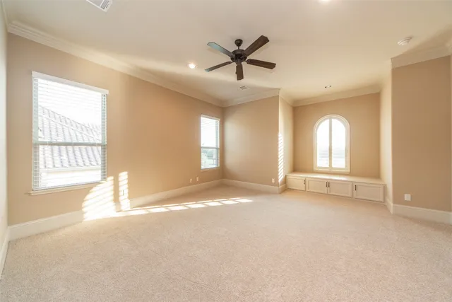 a view of a livingroom with a ceiling fan and window