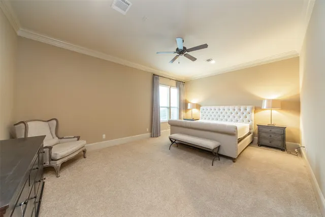 a spacious bedroom with a bed and a couch