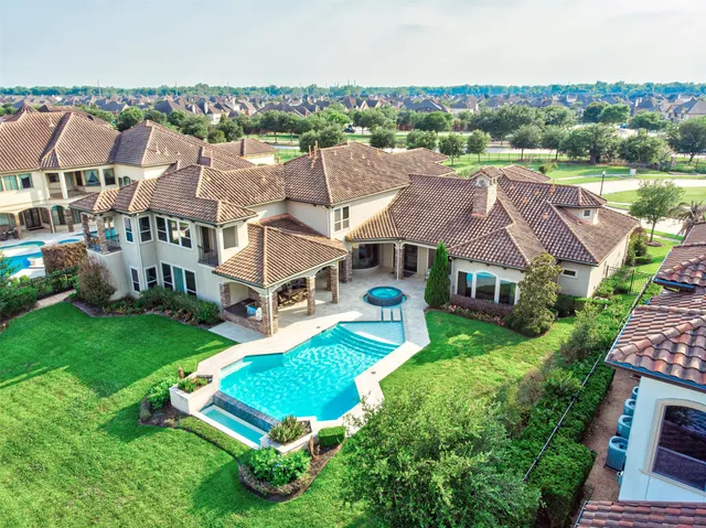 an aerial view of multiple houses with yard