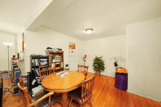 a living room with dining room and wooden floor