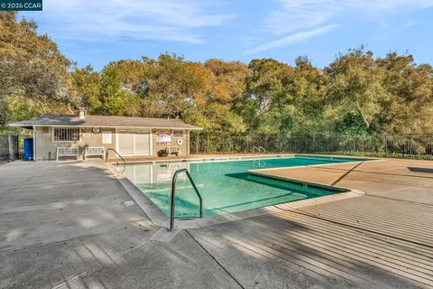 a view of a house with pool and a yard