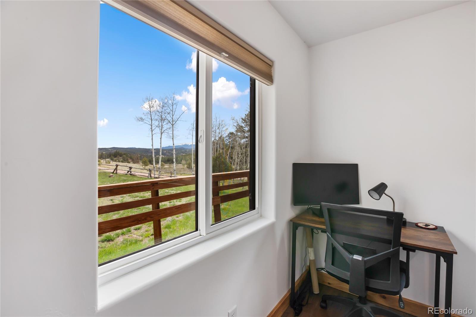 437 Langnis Road Guffey, CO 80820 - Photo 20 of 33 a view of a workspace with furniture and a window