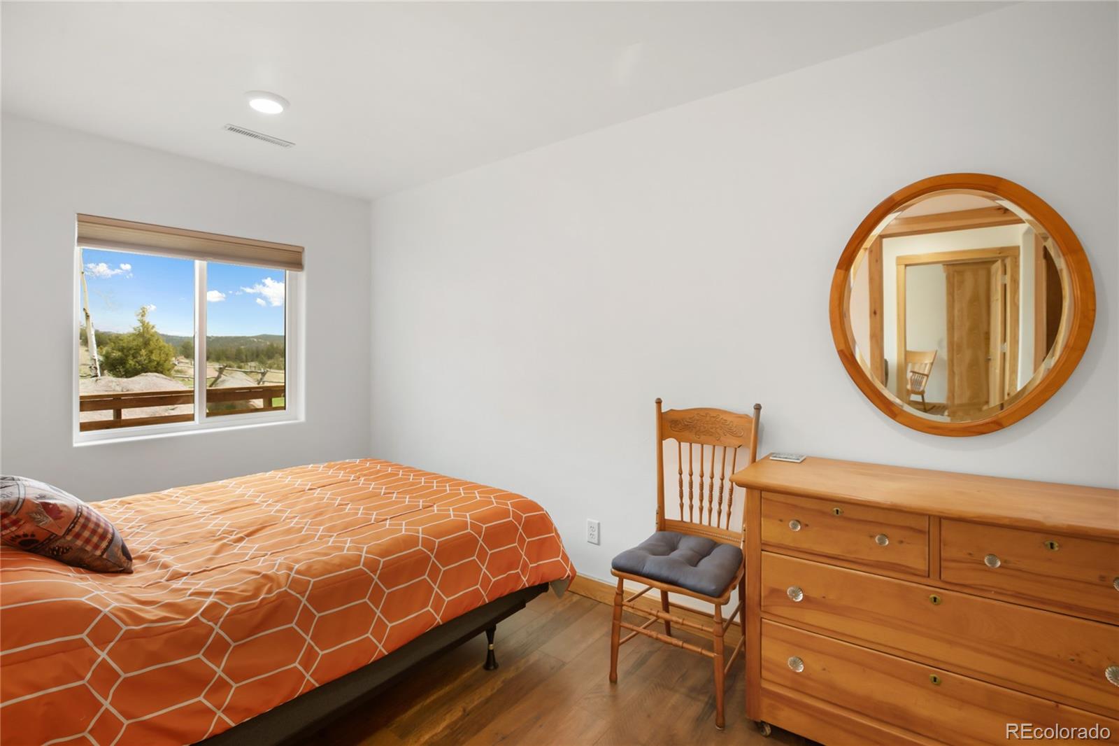 437 Langnis Road Guffey, CO 80820 - Photo 22 of 33 a bedroom with a bed and a dresser with mirror