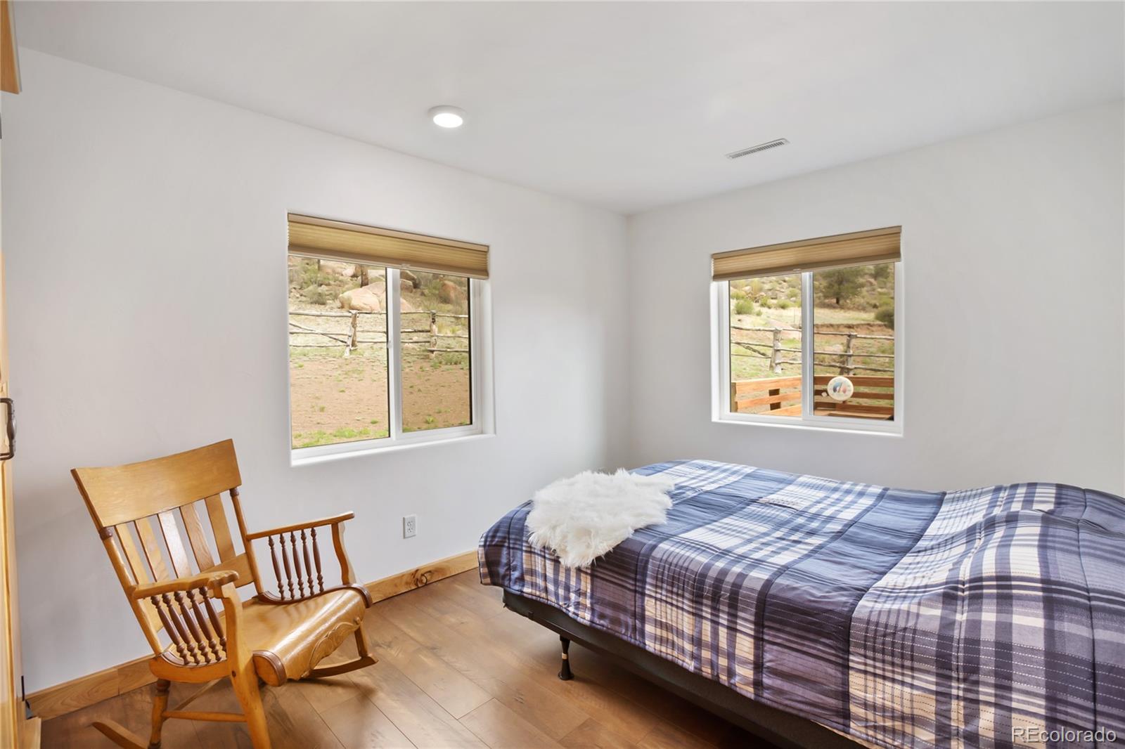 437 Langnis Road Guffey, CO 80820 - Photo 23 of 33 a bedroom with a bed chair and window