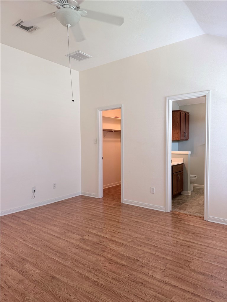 1029 Fallbrook Loop College Station, TX 77845 - Photo 14 of 34 a view of a room with wooden floor closet and a ceiling fan