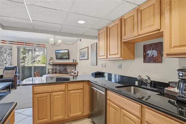 a kitchen with cabinets appliances a sink and a counter top space
