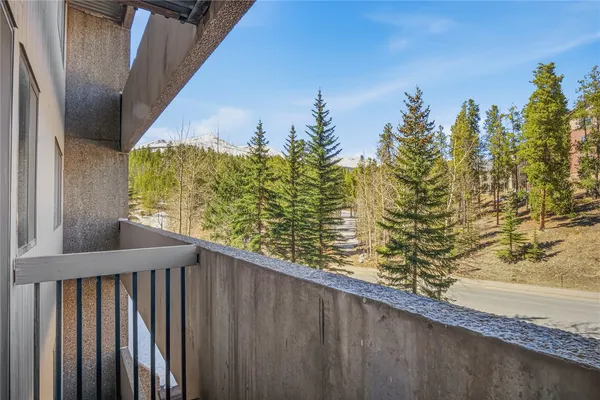 a view of balcony with wooden floor and fence