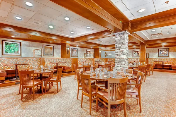 a room with stainless steel appliances kitchen island granite countertop lots of clutter