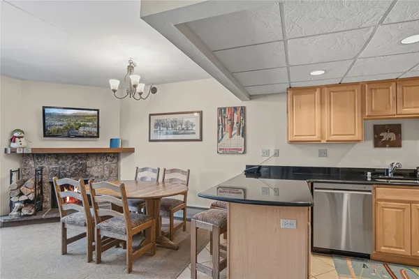a kitchen with a table chairs sink and cabinets