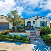a front view of a house with a yard garage and outdoor seating