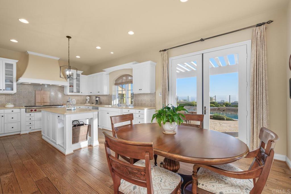7089 Heron Circle Carlsbad, CA 92011 - Photo 14 of 58 a kitchen with kitchen island a large window and cabinets