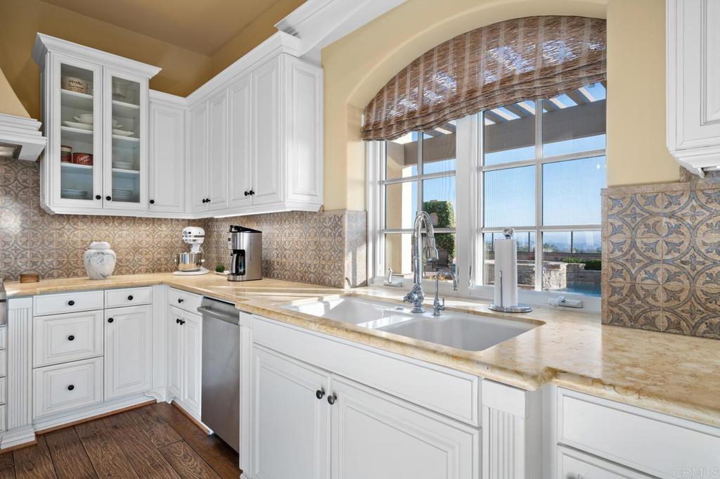 7089 Heron Circle Carlsbad, CA 92011 - Photo 15 of 58 a kitchen with cabinets appliances a sink and a counter top space