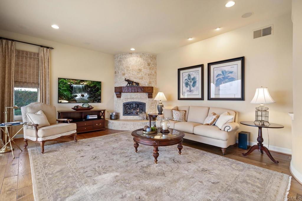 7089 Heron Circle Carlsbad, CA 92011 - Photo 22 of 58 a living room with furniture a rug and a flat screen tv