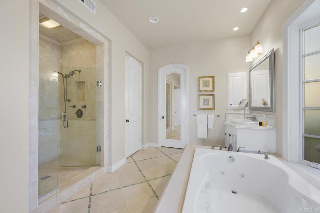 7089 Heron Circle Carlsbad, CA 92011 - Photo 26 of 58 a bathroom with a tub sink and shower