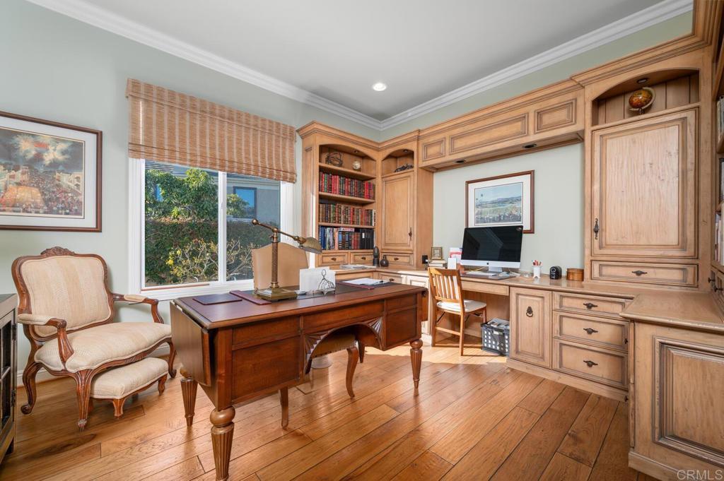 7089 Heron Circle Carlsbad, CA 92011 - Photo 29 of 58 a room with a table chairs and wooden floor