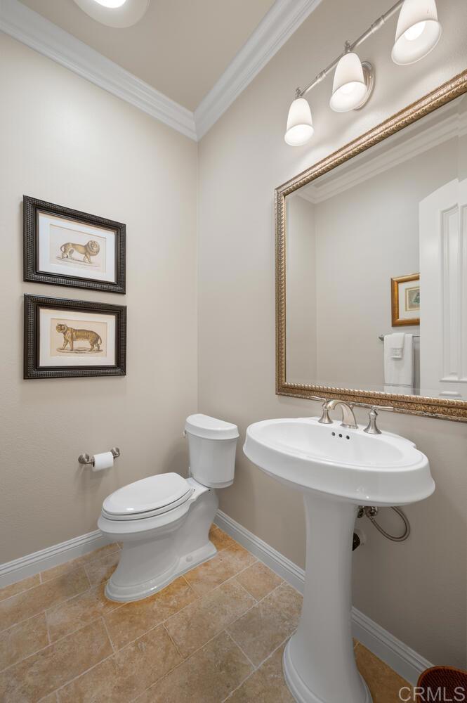 7089 Heron Circle Carlsbad, CA 92011 - Photo 30 of 58 a bathroom with a toilet sink and mirror