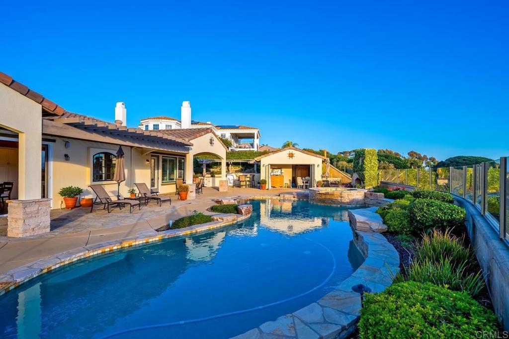 7089 Heron Circle Carlsbad, CA 92011 - Photo 36 of 58 a view of a house with swimming pool and sitting area