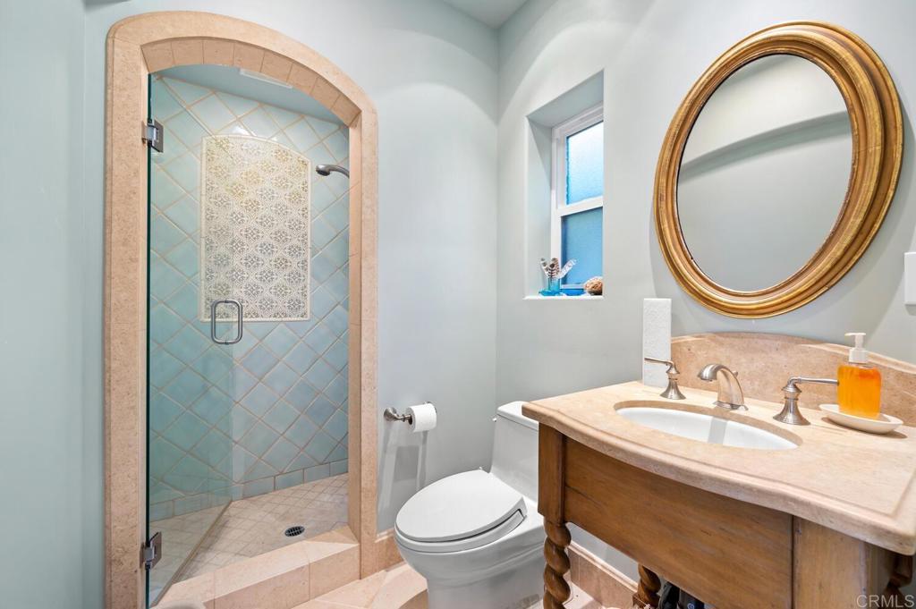 7089 Heron Circle Carlsbad, CA 92011 - Photo 39 of 58 a bathroom with a sink a toilet and a mirror