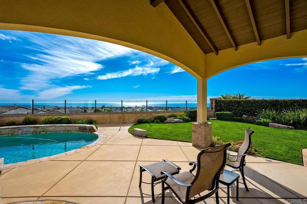 7089 Heron Circle Carlsbad, CA 92011 - Photo 42 of 58 a view of a patio with lawn chairs under an umbrella