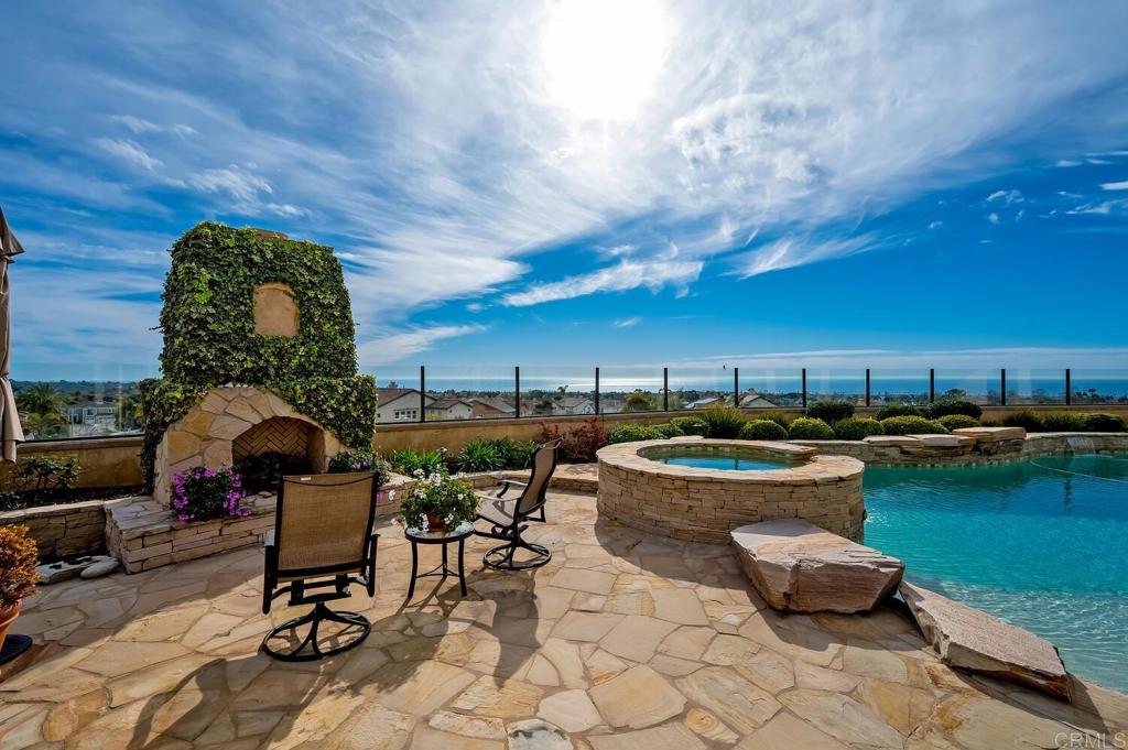 7089 Heron Circle Carlsbad, CA 92011 - Photo 46 of 58 a roof deck with table and chairs and potted plants