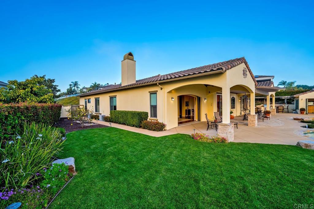 7089 Heron Circle Carlsbad, CA 92011 - Photo 56 of 58 a front view of a house with patio and garden