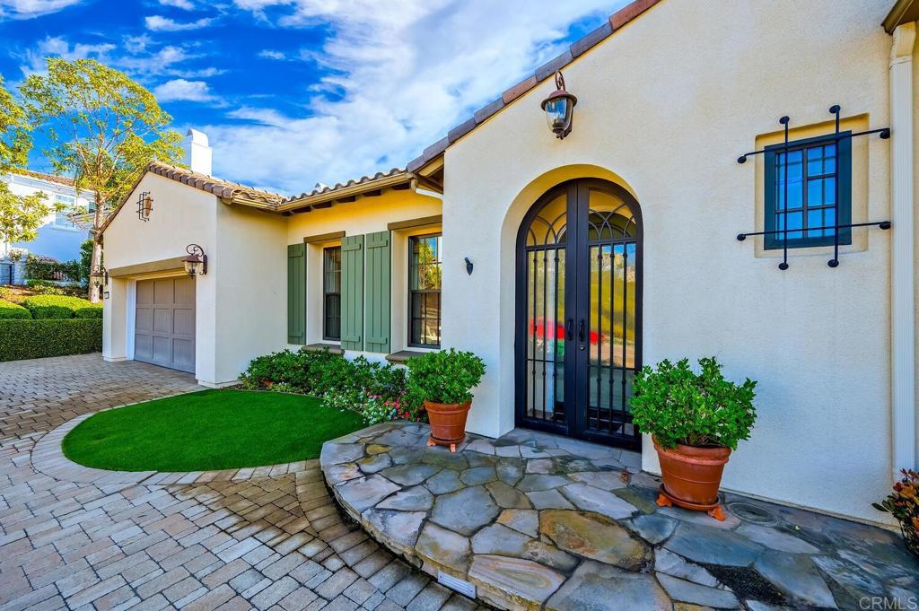 7089 Heron Circle Carlsbad, CA 92011 - Photo 7 of 58 a front view of a house with potted plants