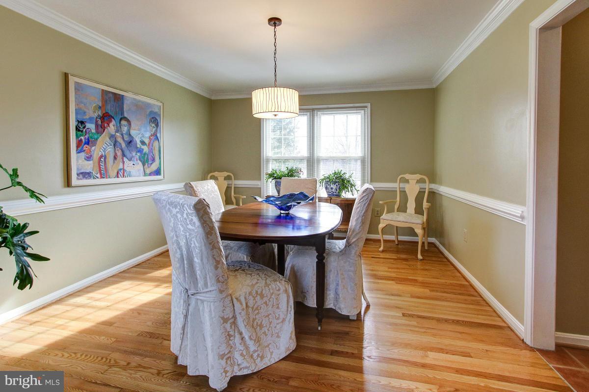 1418 Atwood Road Silver Spring, MD 20906 - Photo 5 of 29 Dining Room w/Wood Flooring/Chair & Crown Molding