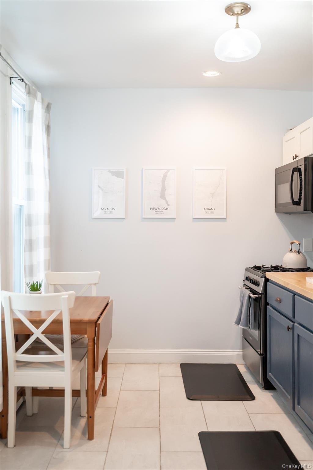 175 Liberty Street Newburgh, NY 12550 - Photo 16 of 50 a room with a chair and white cabinets