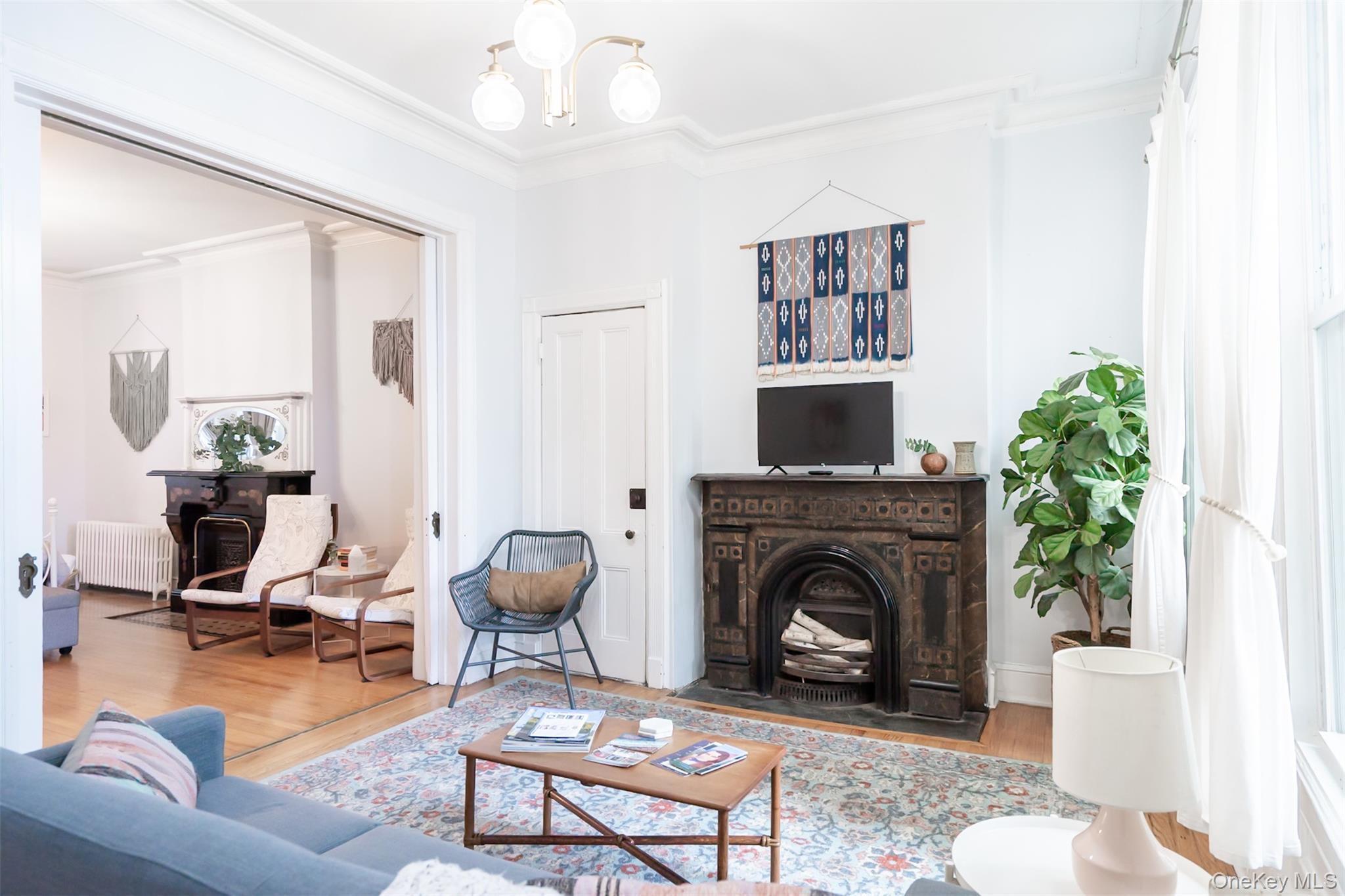 175 Liberty Street Newburgh, NY 12550 - Photo 6 of 50 a living room with furniture a flat screen tv and a fireplace