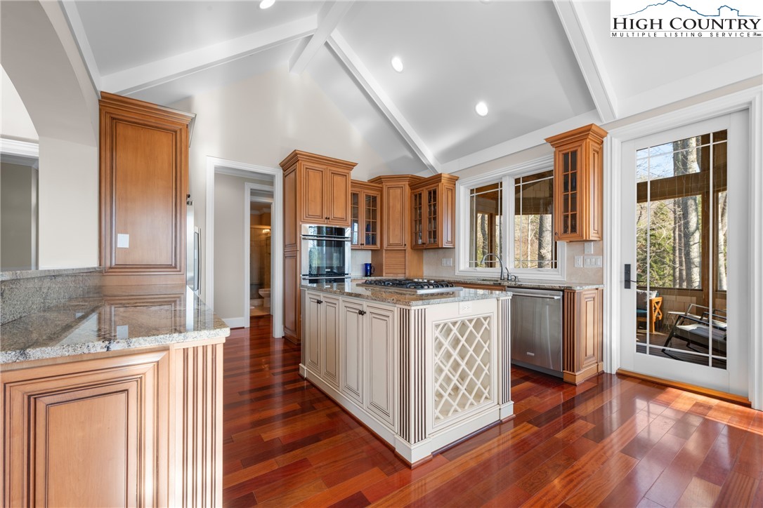 46 North Ridge Lane Newland, NC 28657 - Photo 12 of 46 a kitchen with stainless steel appliances granite countertop a refrigerator a sink dishwasher a stove and white countertops with wooden floor
