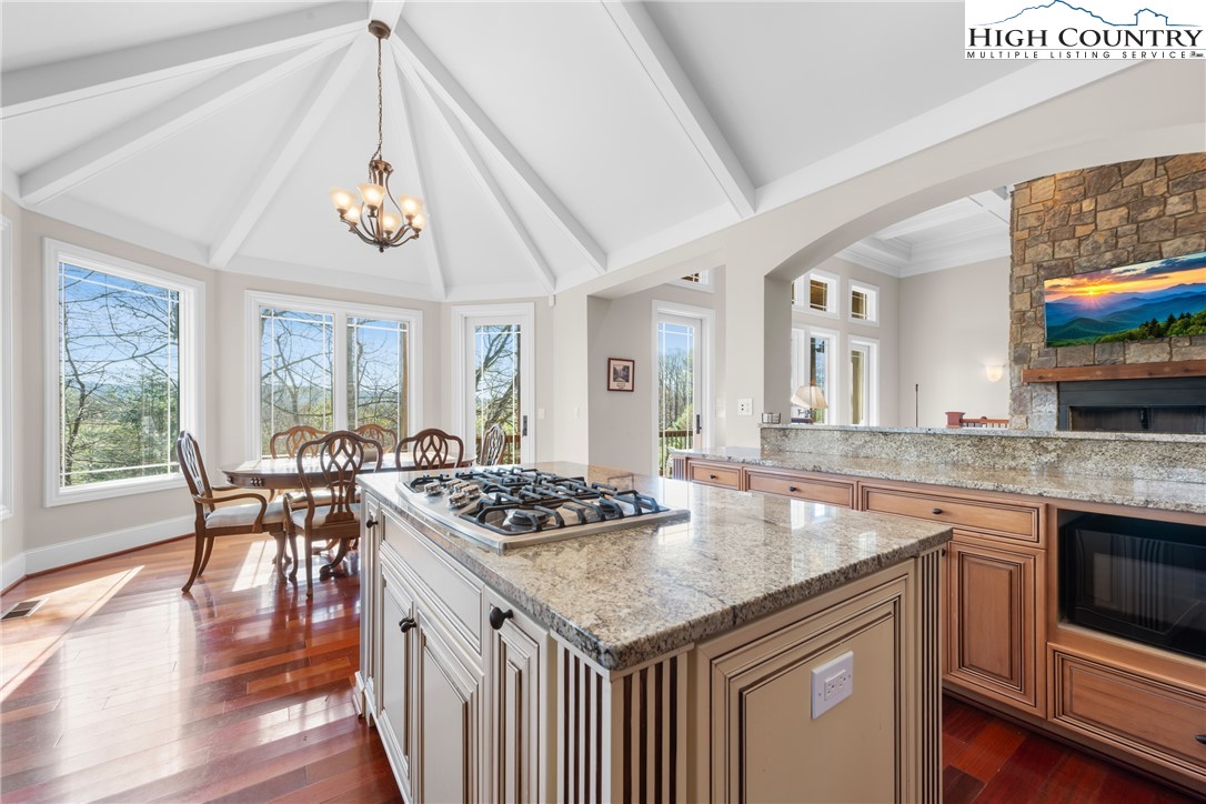 46 North Ridge Lane Newland, NC 28657 - Photo 13 of 46 a kitchen with granite countertop stove a table and chairs in it