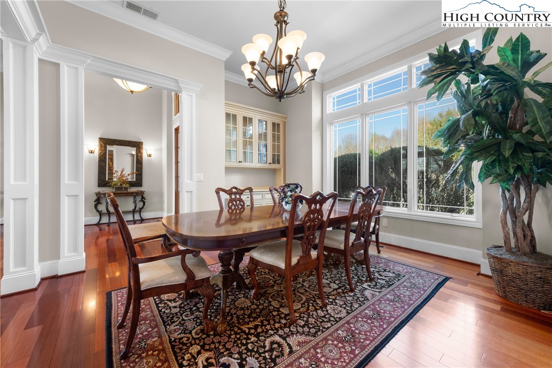 46 North Ridge Lane Newland, NC 28657 - Photo 15 of 46 a dining room with wooden floor a chandelier a wooden table and chairs