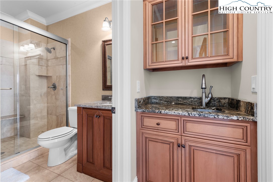46 North Ridge Lane Newland, NC 28657 - Photo 23 of 46 a bathroom with a granite countertop sink a toilet and shower
