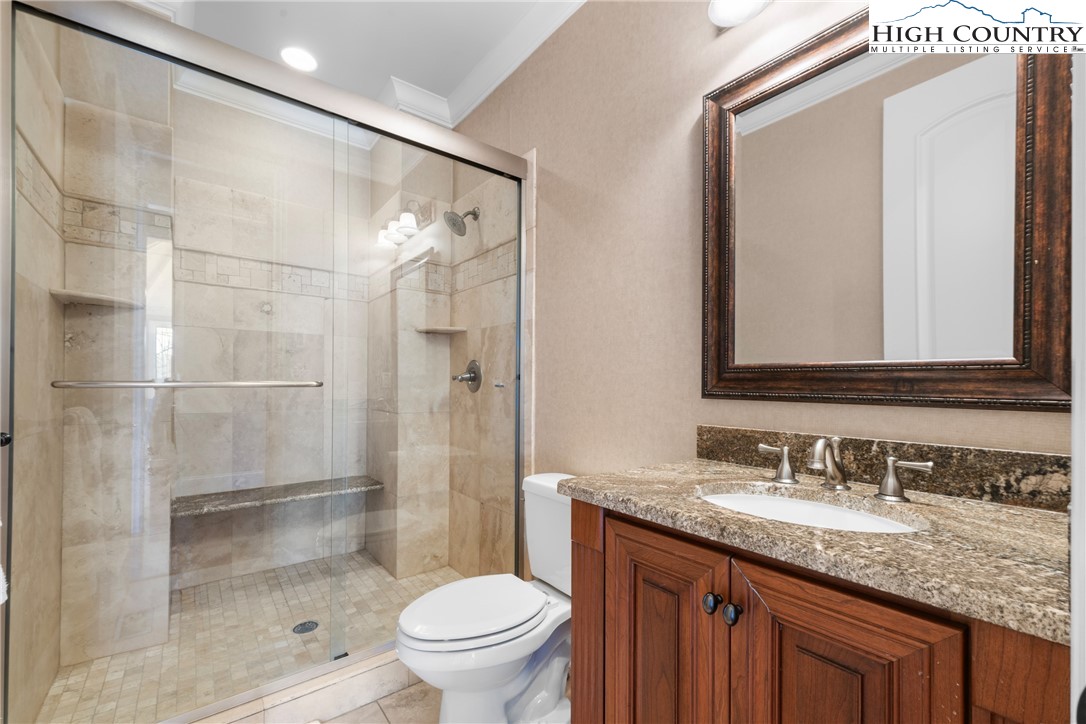 46 North Ridge Lane Newland, NC 28657 - Photo 24 of 46 a bathroom with a granite countertop sink toilet mirror and shower