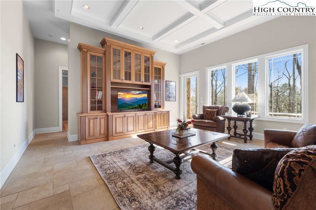 46 North Ridge Lane Newland, NC 28657 - Photo 29 of 46 a living room with furniture a flat screen tv and a floor to ceiling window